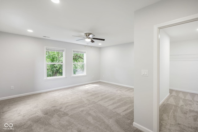 carpeted spare room featuring visible vents, baseboards, ceiling fan, and recessed lighting