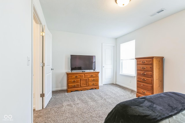carpeted bedroom with visible vents and baseboards