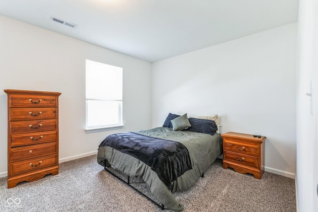 carpeted bedroom with baseboards and visible vents