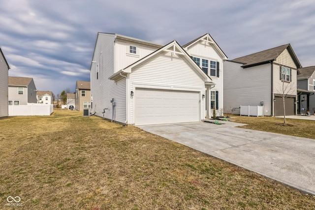 view of front of house with driveway, a front lawn, fence, and a residential view