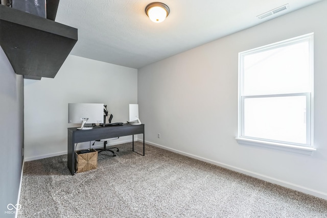 home office featuring carpet floors, baseboards, visible vents, and a textured ceiling