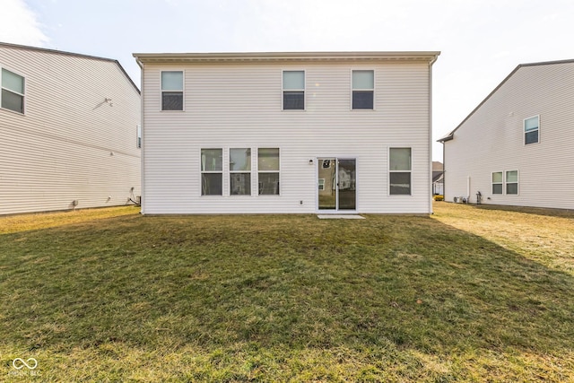 rear view of house featuring a lawn