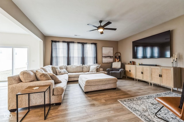 living room featuring light wood-style floors and ceiling fan