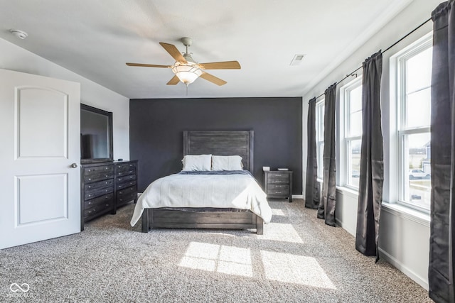 carpeted bedroom featuring visible vents, ceiling fan, and baseboards