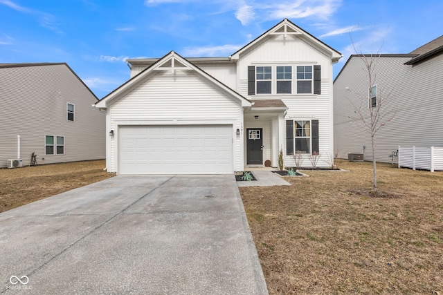 view of front facade featuring a garage, a front yard, concrete driveway, and central AC