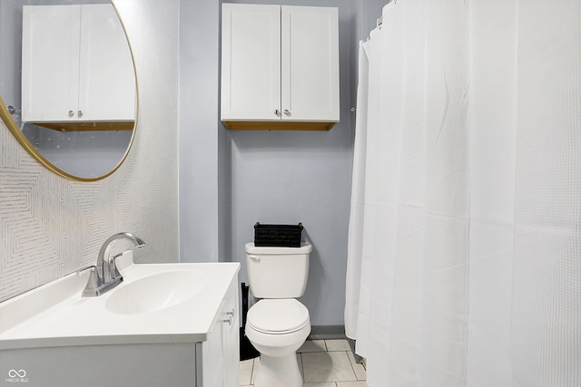 bathroom featuring tile patterned flooring, toilet, a shower with shower curtain, vanity, and baseboards