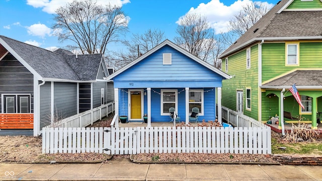 view of front of house with a fenced front yard and a porch