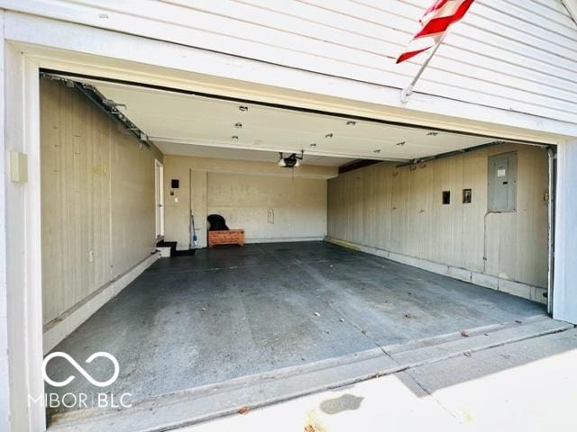 garage with electric panel and a garage door opener