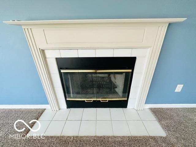 details featuring a fireplace and baseboards