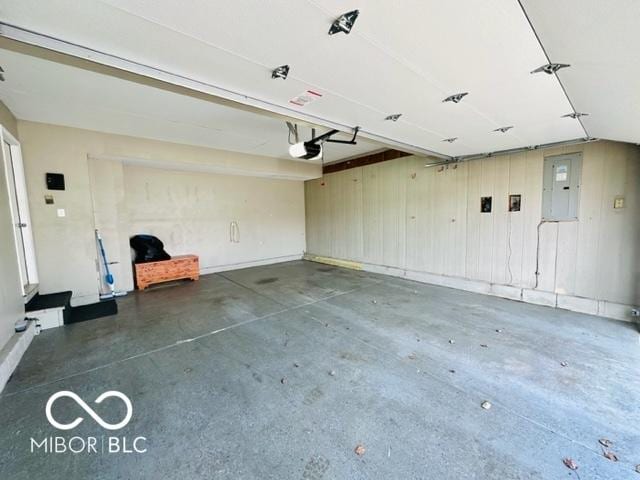 garage featuring electric panel and a garage door opener