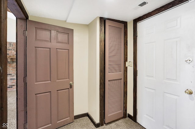 hall with visible vents and baseboards