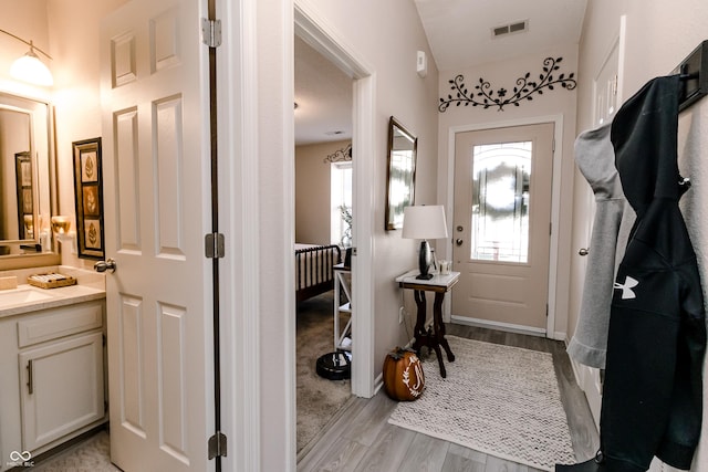 interior space with baseboards, visible vents, and light wood-style floors