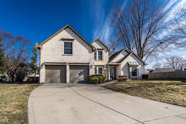 traditional home with concrete driveway, brick siding, fence, and a front lawn