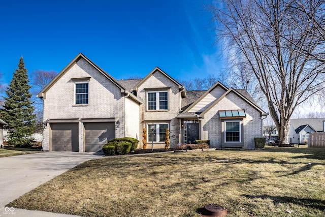 view of front facade with driveway, brick siding, an attached garage, and a front yard