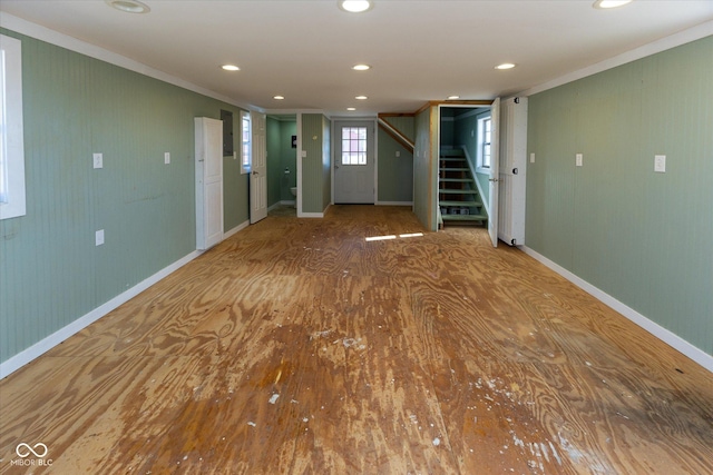 unfurnished room featuring recessed lighting, baseboards, stairway, electric panel, and crown molding