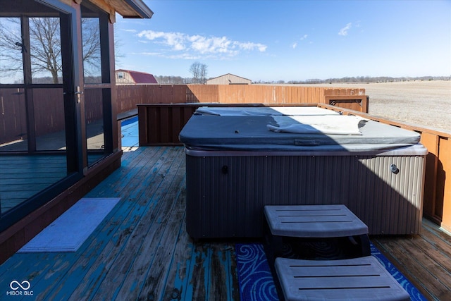 wooden deck featuring fence and a hot tub