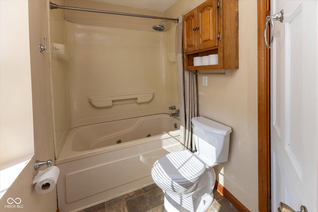 bathroom with toilet and bathtub / shower combination