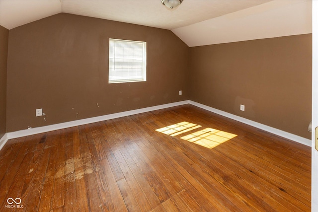 bonus room featuring lofted ceiling, wood-type flooring, and baseboards