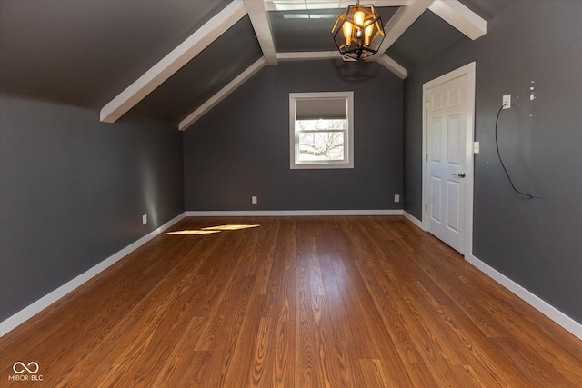 additional living space featuring lofted ceiling, baseboards, and wood finished floors