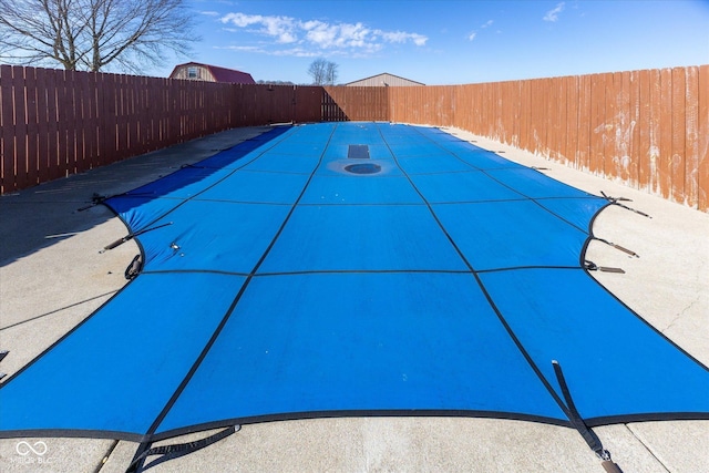 view of swimming pool featuring a fenced backyard