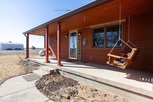 view of exterior entry with covered porch