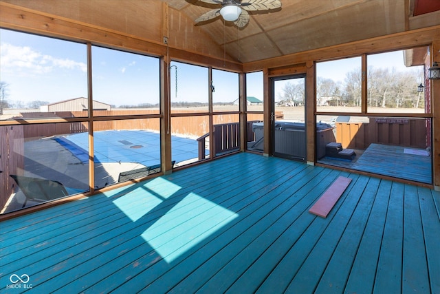 unfurnished sunroom with vaulted ceiling and ceiling fan