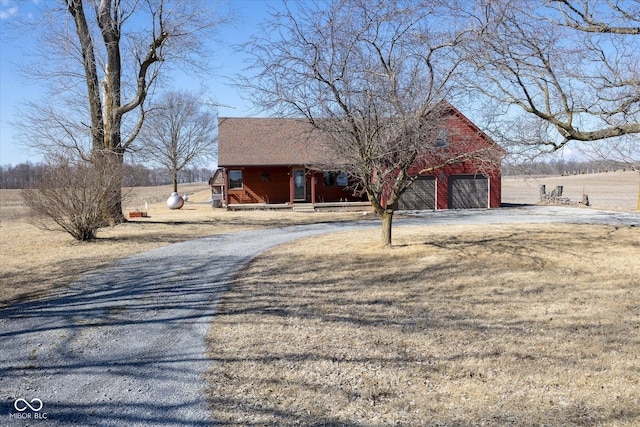 view of front of property featuring aphalt driveway and a garage