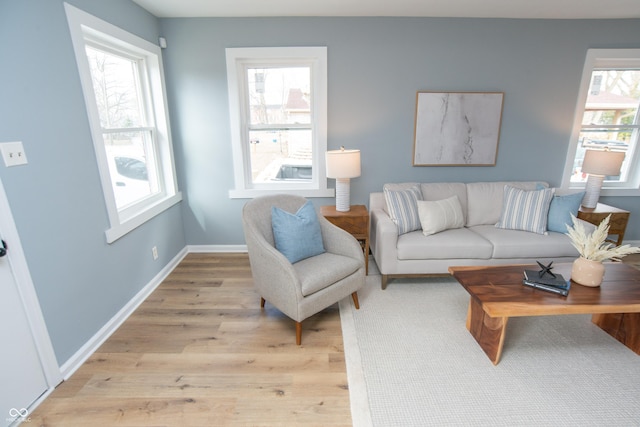 living area with light wood finished floors and baseboards