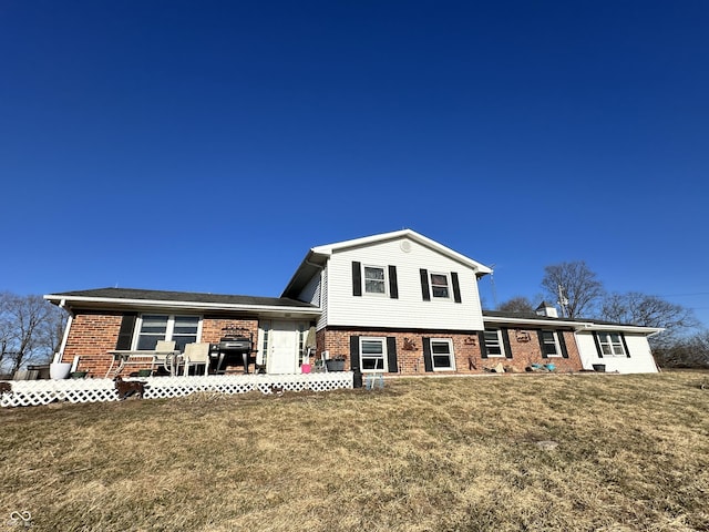 view of front of property featuring a front yard and brick siding