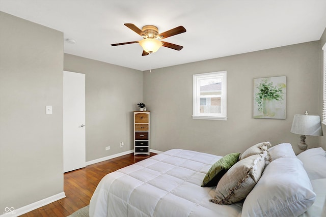 bedroom featuring ceiling fan, wood finished floors, and baseboards