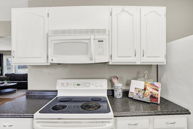 kitchen with white appliances and white cabinets