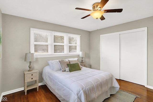 bedroom featuring ceiling fan, a closet, baseboards, and dark wood-type flooring