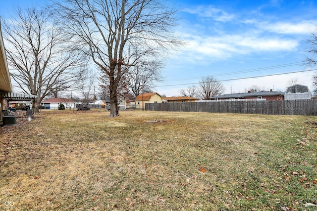 view of yard featuring cooling unit and fence