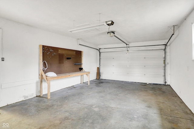 garage featuring a garage door opener and visible vents