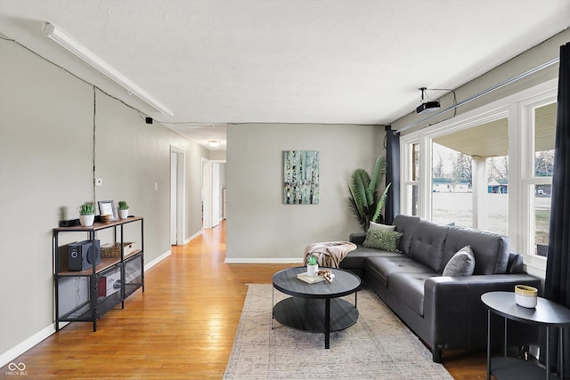 living area with light wood-style floors and baseboards