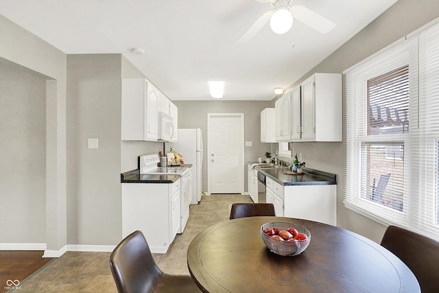 dining area featuring ceiling fan and baseboards