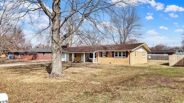 single story home with brick siding, an attached garage, crawl space, fence, and a front lawn