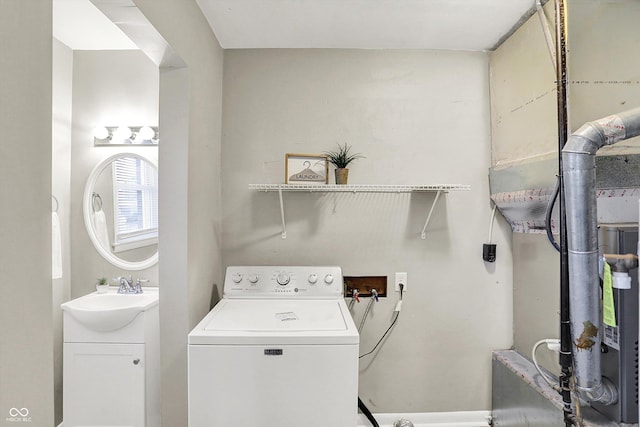 laundry room with laundry area, washer / clothes dryer, and a sink