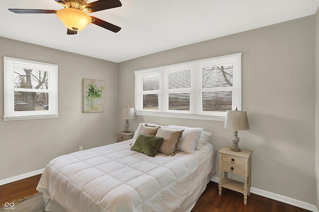 bedroom with dark wood-style floors, baseboards, and a ceiling fan