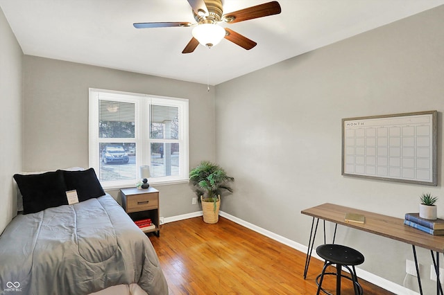 bedroom featuring a ceiling fan, hardwood / wood-style flooring, and baseboards