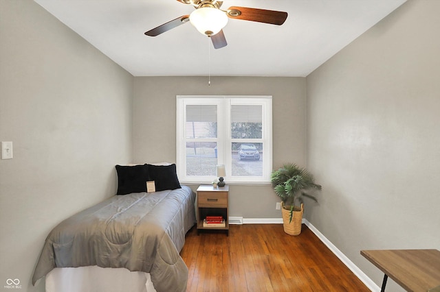 bedroom featuring ceiling fan, baseboards, and hardwood / wood-style flooring