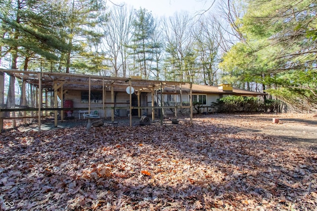 back of house with an outbuilding