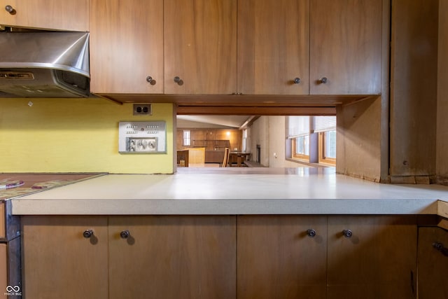 kitchen with ventilation hood and light countertops