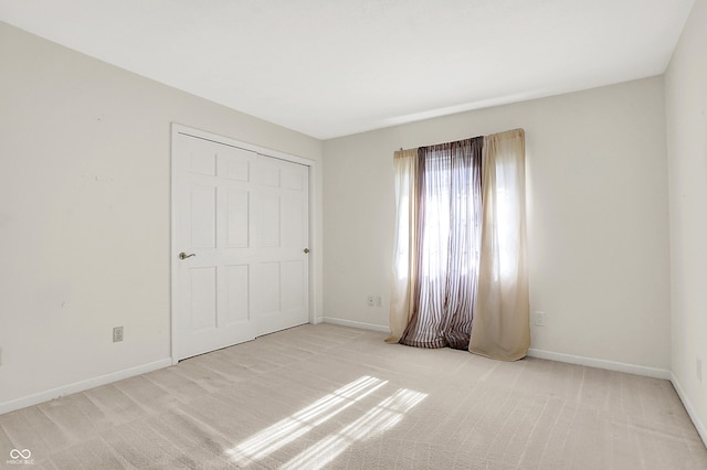 unfurnished bedroom with carpet flooring and baseboards