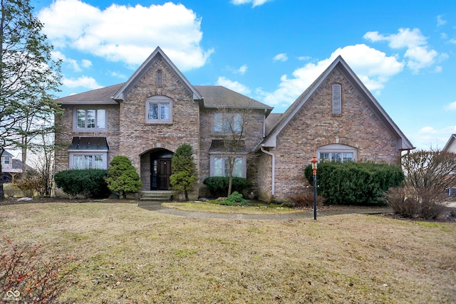 view of front of property featuring brick siding and a front lawn