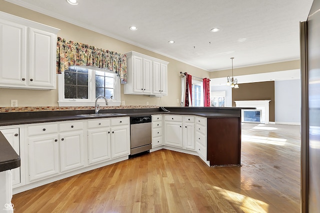 kitchen featuring dark countertops, a healthy amount of sunlight, a sink, and stainless steel dishwasher