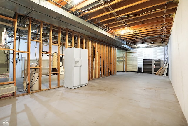 basement with white fridge with ice dispenser