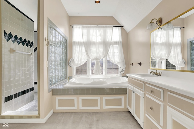 full bath featuring vaulted ceiling, walk in shower, a garden tub, and vanity