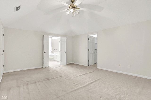 unfurnished bedroom featuring baseboards, visible vents, a walk in closet, and ensuite bathroom