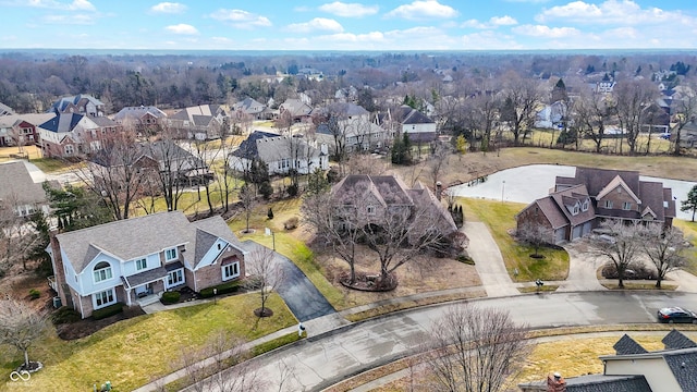 bird's eye view featuring a water view and a residential view